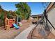 Backyard features a swing set and covered patio seating at 5220 Shasta Daisy St, North Las Vegas, NV 89031