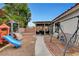 Backyard with a swing, patio seating, and a slide at 5220 Shasta Daisy St, North Las Vegas, NV 89031
