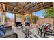 Lush backyard featuring covered patio, comfortable seating, swing set, and blooming flowers at 5220 Shasta Daisy St, North Las Vegas, NV 89031