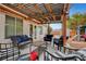 Relaxing backyard with covered patio, comfortable seating, lush greenery, and play structures at 5220 Shasta Daisy St, North Las Vegas, NV 89031