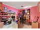 Pink bedroom with a shelf holding items at 5220 Shasta Daisy St, North Las Vegas, NV 89031