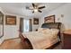 Comfortable bedroom with classic décor, a ceiling fan, and ample natural light from the window at 5220 Shasta Daisy St, North Las Vegas, NV 89031