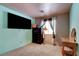 Inviting bedroom with soft carpet, a TV, and a well-lit window area with stylish décor at 5220 Shasta Daisy St, North Las Vegas, NV 89031