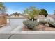 Charming single-story home with a well-maintained front yard and attached two car garage at 5220 Shasta Daisy St, North Las Vegas, NV 89031