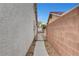 Narrow side yard with a walkway and gate at 5220 Shasta Daisy St, North Las Vegas, NV 89031