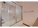 Bathroom with tiled shower, grab bar, and sleek sliding glass doors at 5274 Somerset Dr, Las Vegas, NV 89120