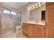 Bathroom vanity with wood cabinets, a glass-enclosed shower, and tile flooring at 5274 Somerset Dr, Las Vegas, NV 89120