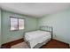 This bedroom features light green walls, a window with blinds, and a bed with a white comforter at 5274 Somerset Dr, Las Vegas, NV 89120