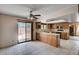 Eat-in kitchen with wood cabinets, tile flooring, and a sliding glass door to the backyard at 5274 Somerset Dr, Las Vegas, NV 89120