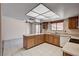 Bright kitchen with tile floors, wood cabinetry, and a view of the backyard through the window at 5274 Somerset Dr, Las Vegas, NV 89120