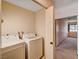 Laundry room equipped with white washer and dryer machines at 5274 Somerset Dr, Las Vegas, NV 89120