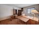This office features a large desk, shelving, a window and vintage style lighting at 5274 Somerset Dr, Las Vegas, NV 89120