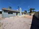 Cozy backyard with a concrete patio and low maintenance gravel landscaping under a bright blue sky at 5460 Conville Pl, Las Vegas, NV 89120