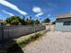 Fully fenced backyard with low maintenance gravel landscaping and view of the street and neighborhood at 5460 Conville Pl, Las Vegas, NV 89120