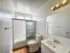 Bright bathroom featuring tiled shower/tub combo, single sink vanity, and wood look flooring at 5460 Conville Pl, Las Vegas, NV 89120