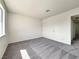 Well-lit bedroom featuring neutral carpet and a closet with sliding doors for ample storage at 5460 Conville Pl, Las Vegas, NV 89120