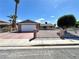 Charming single-story home featuring a gated entrance, red brick accents, and a two-car garage in a sunny neighborhood at 5460 Conville Pl, Las Vegas, NV 89120