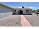 Charming single-story home featuring a unique arched entryway and low-maintenance gravel front yard at 5460 Conville Pl, Las Vegas, NV 89120