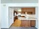 A view into a kitchen with tile countertops, wood cabinetry, and stainless steel appliances enhancing this design at 5460 Conville Pl, Las Vegas, NV 89120