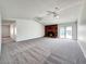 Spacious living room featuring plush carpeting, a brick fireplace, and vaulted ceilings at 5460 Conville Pl, Las Vegas, NV 89120