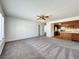 Spacious living room area with open flow into the kitchen featuring wooden cabinets and tile countertops at 5460 Conville Pl, Las Vegas, NV 89120