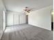 Main bedroom with plush carpeting, wide closet, neutral color palette, and natural light at 5460 Conville Pl, Las Vegas, NV 89120