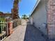 Side yard area of home with gravel landscaping leading to gated access at 5460 Conville Pl, Las Vegas, NV 89120