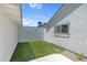 Small backyard with synthetic grass and perimeter landscaping at 6181 Cedarwood Ave, Las Vegas, NV 89103