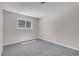 Carpeted bedroom with gray walls featuring a window with security bars at 6181 Cedarwood Ave, Las Vegas, NV 89103