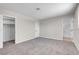 Bedroom with neutral carpet, doors to bathroom and closet at 6181 Cedarwood Ave, Las Vegas, NV 89103