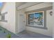 Inviting home entrance featuring a secure screen door, decorative window bars, and freshly planted greenery at 6181 Cedarwood Ave, Las Vegas, NV 89103