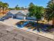 Lovely single-story home with an attached garage and lush front yard as seen from an elevated vantage point at 6181 Cedarwood Ave, Las Vegas, NV 89103