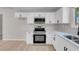 Modern kitchen boasts stainless steel appliances, white cabinetry, and a stainless steel sink at 6181 Cedarwood Ave, Las Vegas, NV 89103