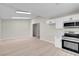 Bright kitchen features new appliances, white cabinets, and stylish wood-look floors at 6181 Cedarwood Ave, Las Vegas, NV 89103