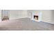 Bright living room featuring plush gray carpeting and a cozy fireplace with a white brick surround at 6181 Cedarwood Ave, Las Vegas, NV 89103