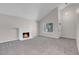 Charming living room with cozy fireplace, large window, and a seamless transition to the adjacent spaces at 6181 Cedarwood Ave, Las Vegas, NV 89103
