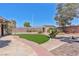 Lush backyard with artificial turf, desert plants, and a storage shed at 6224 Red Pine Ct, Las Vegas, NV 89130