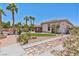 Beautiful backyard showcasing lush landscaping, an outdoor kitchen, and access to the pool area at 6224 Red Pine Ct, Las Vegas, NV 89130