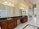 Main bathroom with double sinks, granite countertops, and custom cabinetry at 6224 Red Pine Ct, Las Vegas, NV 89130