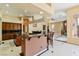 Open-concept kitchen boasts dark wood cabinetry, marble floors, and granite countertops at 6224 Red Pine Ct, Las Vegas, NV 89130