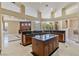 Open concept kitchen with granite countertops, an island, and cherry wood cabinetry at 6224 Red Pine Ct, Las Vegas, NV 89130