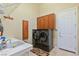Well-organized laundry room with modern washer/dryer, sink, and storage cabinets at 6224 Red Pine Ct, Las Vegas, NV 89130