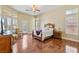 Bright main bedroom with a ceiling fan, hardwood floors, and access to a balcony at 6224 Red Pine Ct, Las Vegas, NV 89130