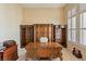 Spacious home office featuring custom wood cabinetry and a large desk at 6224 Red Pine Ct, Las Vegas, NV 89130