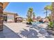 Beautiful backyard pool with tropical landscaping and a custom rock slide feature at 6224 Red Pine Ct, Las Vegas, NV 89130