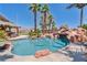 Gorgeous pool area featuring a grotto, rock features, and a thatched-roof tiki bar at 6224 Red Pine Ct, Las Vegas, NV 89130
