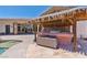 Outdoor kitchen area with grill, countertop space, and bar seating near the custom pool at 6224 Red Pine Ct, Las Vegas, NV 89130