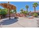 Poolside area with custom fire pit and thatched-roof bar at 6224 Red Pine Ct, Las Vegas, NV 89130
