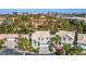 An aerial view displays a home's landscaping, the surrounding neighborhood, and a striking city skyline at 6259 Santander Ave, Las Vegas, NV 89103