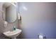 Powder room with pedestal sink, oval mirror, and neutral wall color at 6259 Santander Ave, Las Vegas, NV 89103